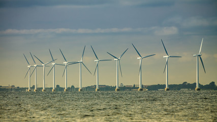 wind turbines power generator farm along coast sea