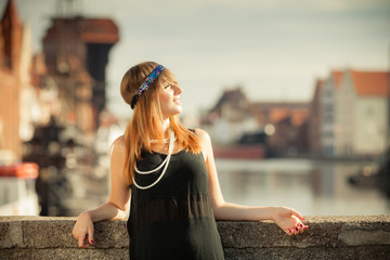 Flapper girl woman in1920s style standing on the street