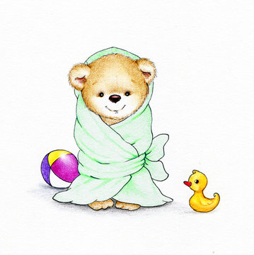 Teddy bear wrapped in a green blanket and toys