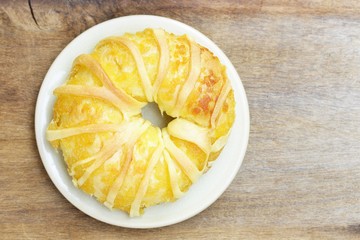 Pineapple bread in white plate on wood table