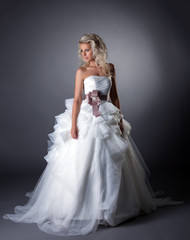 Majestic bride posing in lush wedding dress