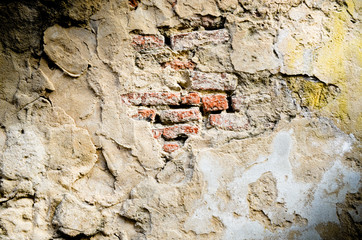 Old red brick  in cracked concrete wall