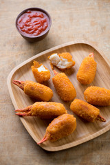 Breaded crab claws with dipping sauce, high angle view