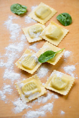 Raw italian ravioli with flour, selective focus, studio shot