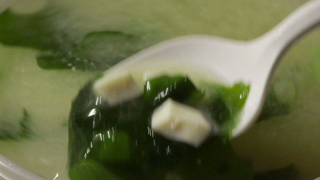 Japanese cuisine - Hot Miso soup stirred with spoon