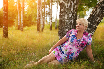 Smiling senior woman sitting in the park