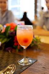 Glass of orange juice on the table.