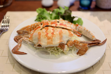 Crabs in white dish.