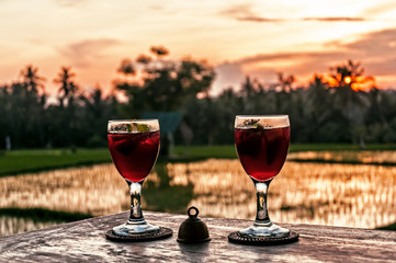 Two wine glasses at  the sunset