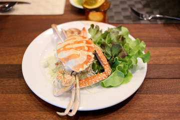 Crabs in white dish.