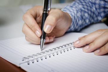 Closeup of secretary's hand doing paperwork