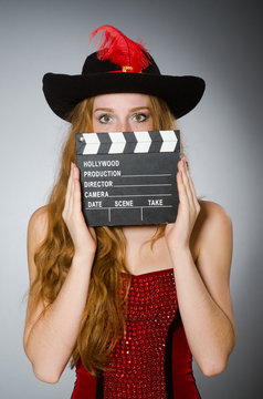 Woman in pirate costume with movie board