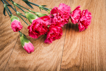 Pink carnations flower bouquet on rustic background