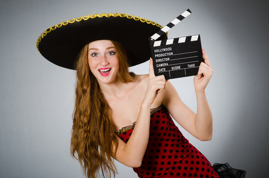 Funny mexican woman with sombrero and movie clapboard