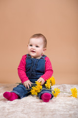 smiling infant baby with yellow flowers