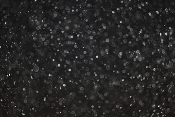 texture of white rain drops on a black background 