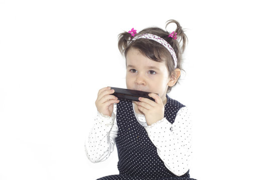 Little girl playing harmonica