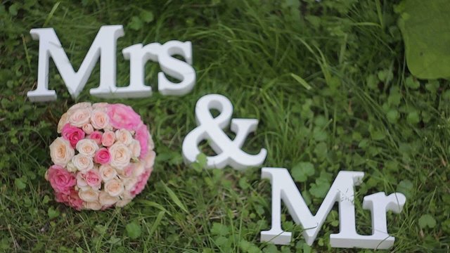 Mr. and Mrs. inscription with wedding bouquet