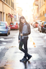 Brunette woman portrait posing in the street. Back light effect,
