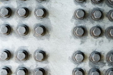 Gray metal surface with hexagonal bolt heads