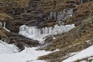 Fototapeta na wymiar Avalanche snow slide ice falling from rocks