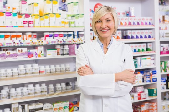 Blonde Pharmacist With Arms Crossed Smiling At Camera