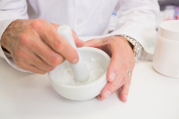 Close up of pharmacist mixing medicine