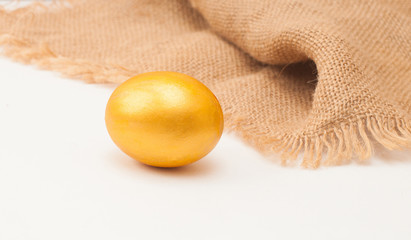golden egg with sacking on white background