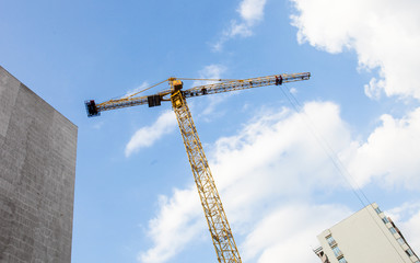Tower crane against the cloudy sky