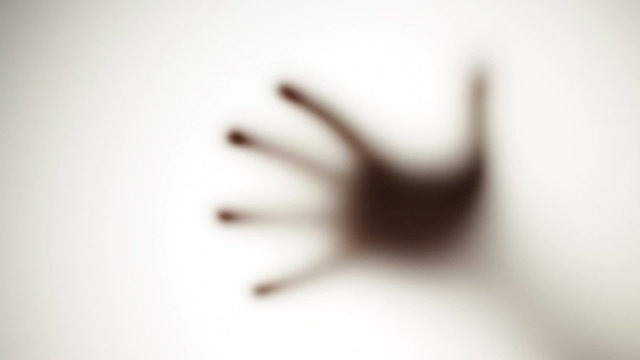 Spooky defocused hand - behind frosted glass