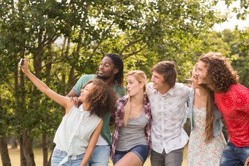 Happy friends in the park taking selfie