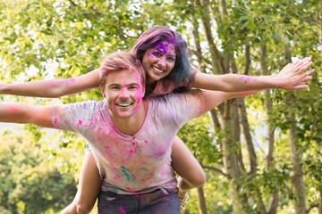 Happy friends covered in powder paint