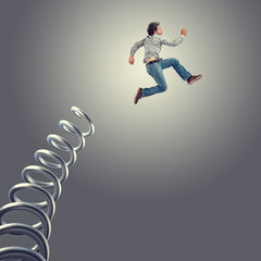 man jumps steel spring,concept advantage,success,determination,cunning,business