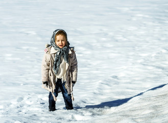 Fototapeta na wymiar Cute little girl portrait in snow field