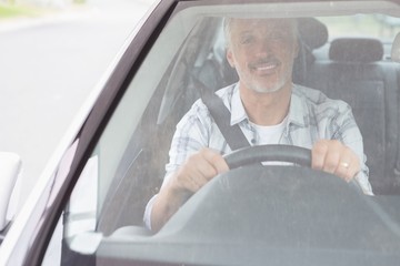 Man smiling while driving