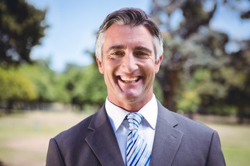 Businessman smiling in the park