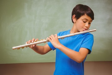 Little boy playing flute in classroom © WavebreakmediaMicro