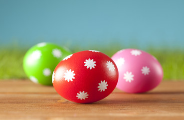 Three Easter eggs on wooden planks