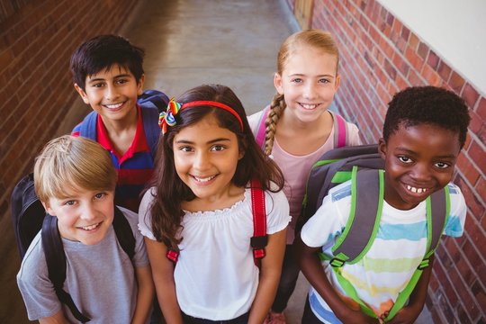 Smiling little school mixed race kids in school corridor - Powered by Adobe