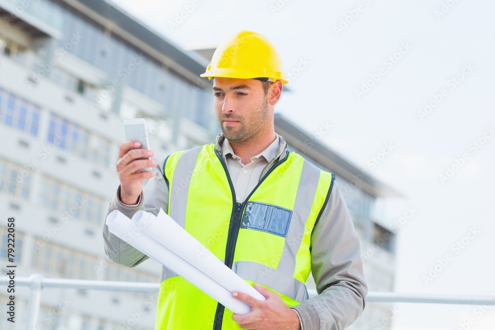 Aufkleber architect using smartphone against building