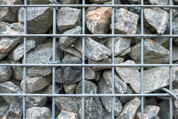 Wall of steel and stones in winter