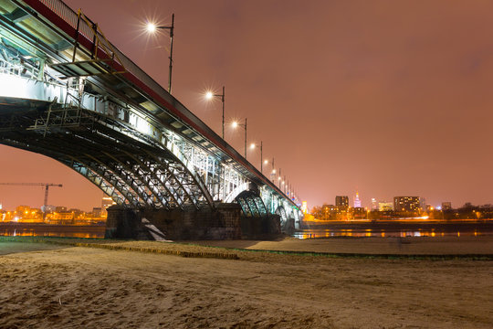 Fototapeta Poniatowski bridge over Vistula river illuminated in Warsaw