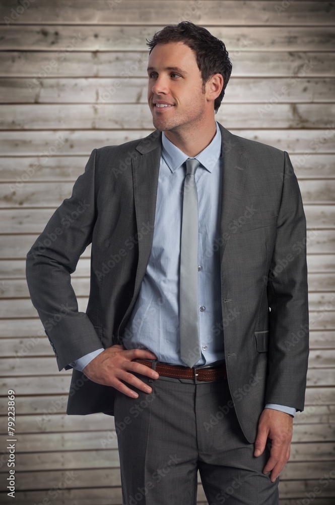 Poster composite image of smiling businessman with hand on hip