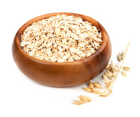 Rolled oats in a bowl isolated on white background