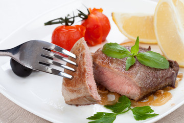 Grilled meat and spices lie on a board