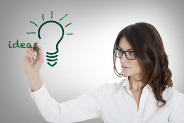 woman writing on glass board