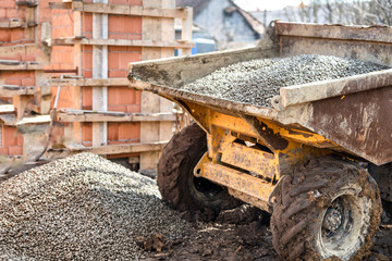 Dumper truck unloading construction gravel and curshed stones