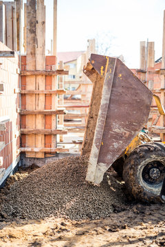 Dumper truck unloading construction gravel, granite, stones