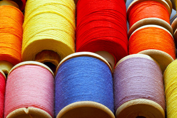 Coils with color threads. Industrial background.