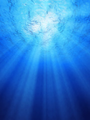 Blue ocean underwater light rays.